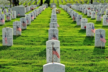 Old Guard soldiers plant flags at Arlington National Cemetery